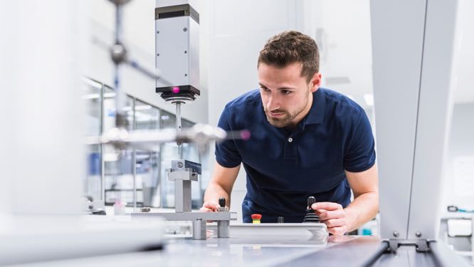 man interacting with industrial machinery